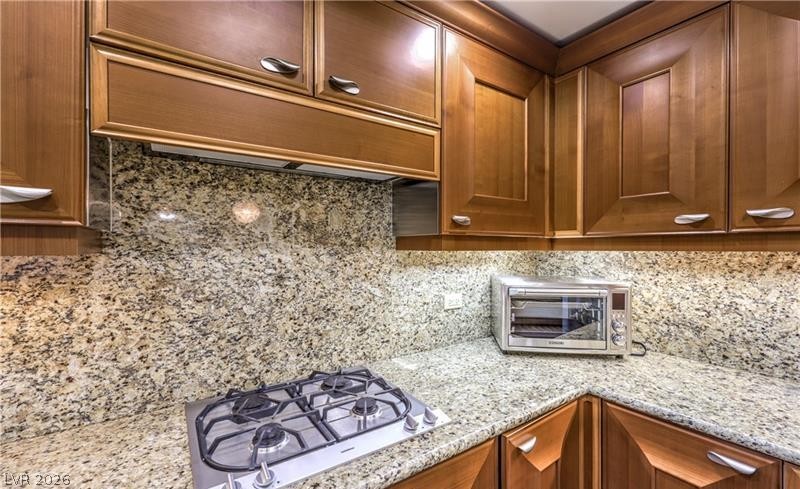 2777 Paradise Road, Unit 807 Las Vegas, NV 89109 - Photo 35 of 61 Culinary delights await in this kitchen, featuring a built-in gas range and gleaming granite surfaces.