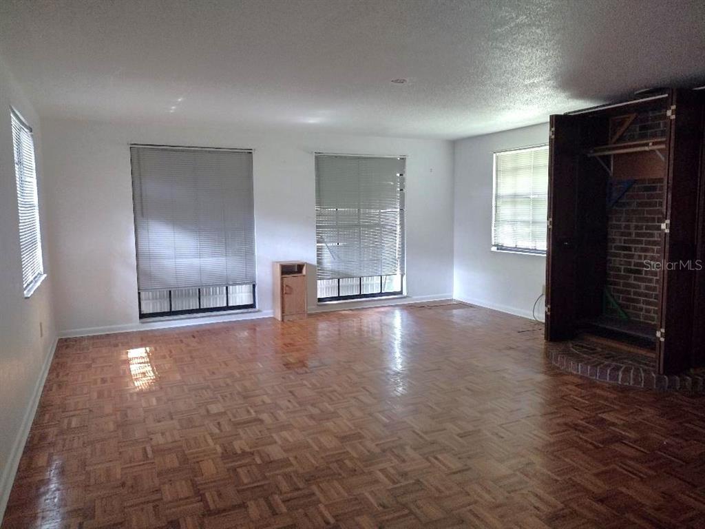 651 Old Haw Creek Road Bunnell, FL 32110 - Photo 3 of 28 wooden floor in an empty room with a window