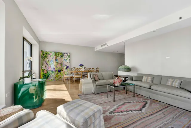 a living room with furniture and large windows