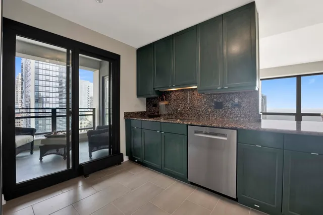 a kitchen with stainless steel appliances kitchen island granite countertop a refrigerator and a stove