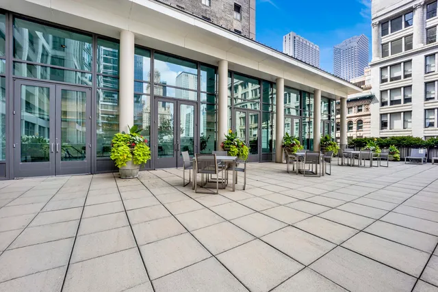 a view of a patio with couches table and chairs and potted plants