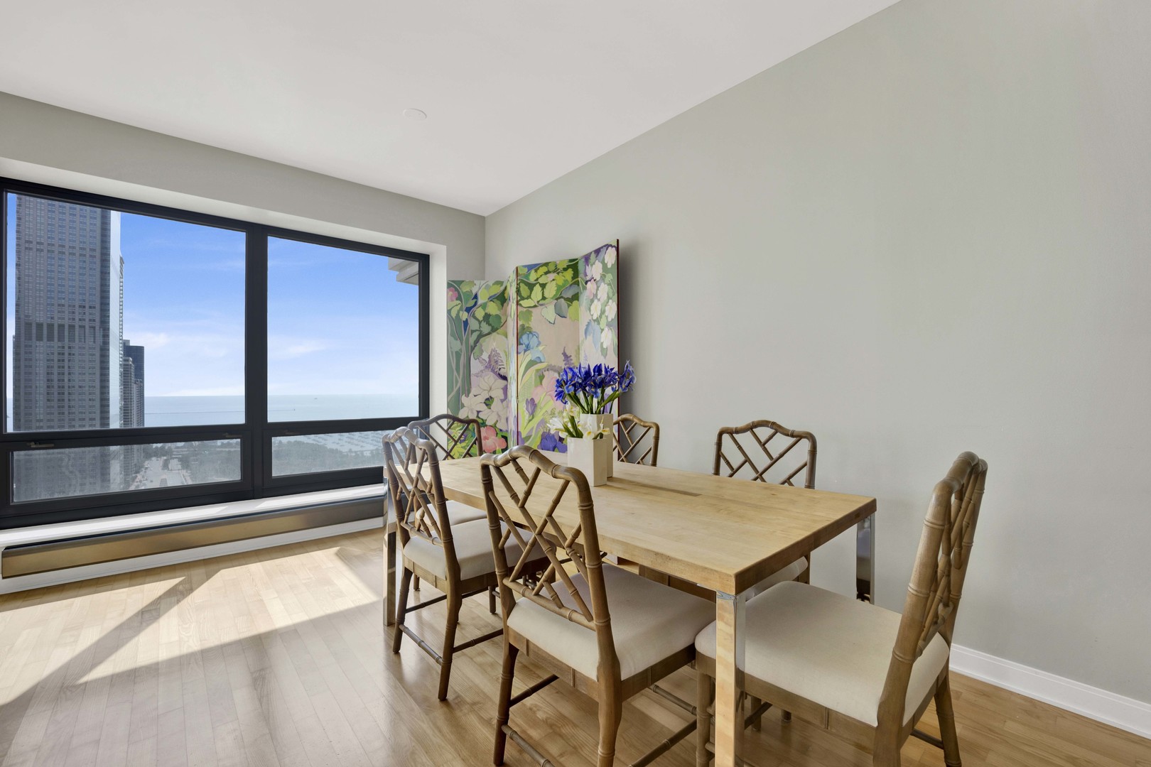 130 North Garland Court, Unit 3001 Chicago, IL 60602 - Photo 7 of 63 a view of a dining room with furniture one side kitchen view and wooden floor