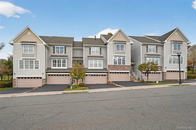 a front view of residential houses with yard