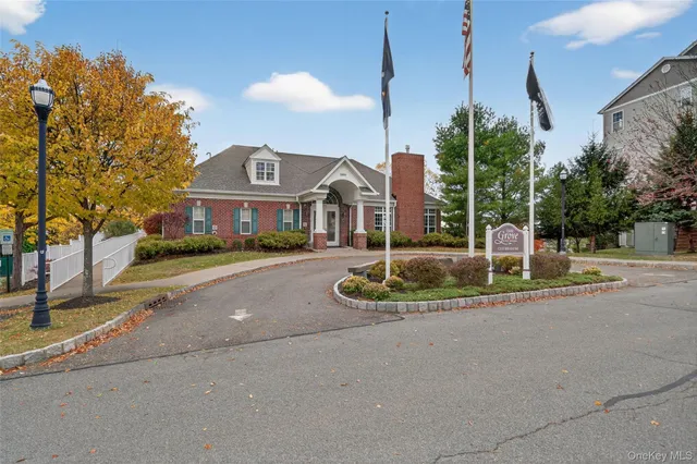 a front view of a house with a yard and palm trees