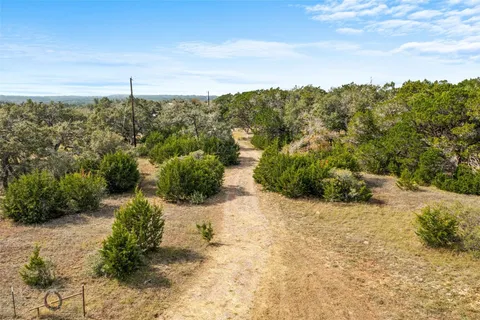 a view of a large yard with lots of trees