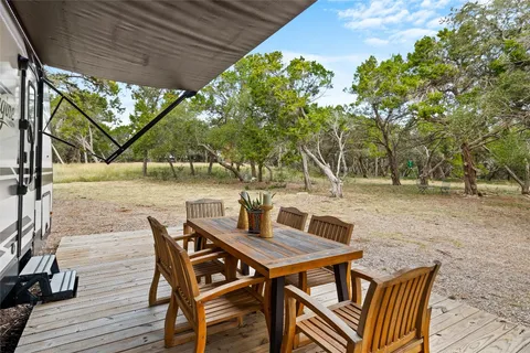a view of a house with backyard porch and sitting area