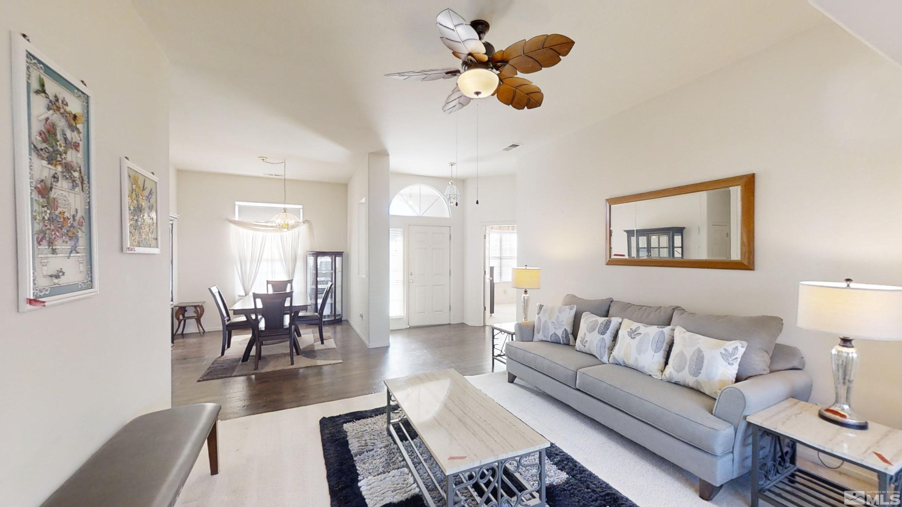 10421 Silver Rush Court Reno, NV 89521 - Photo 8 of 30 a living room with furniture kitchen view and a wooden floor