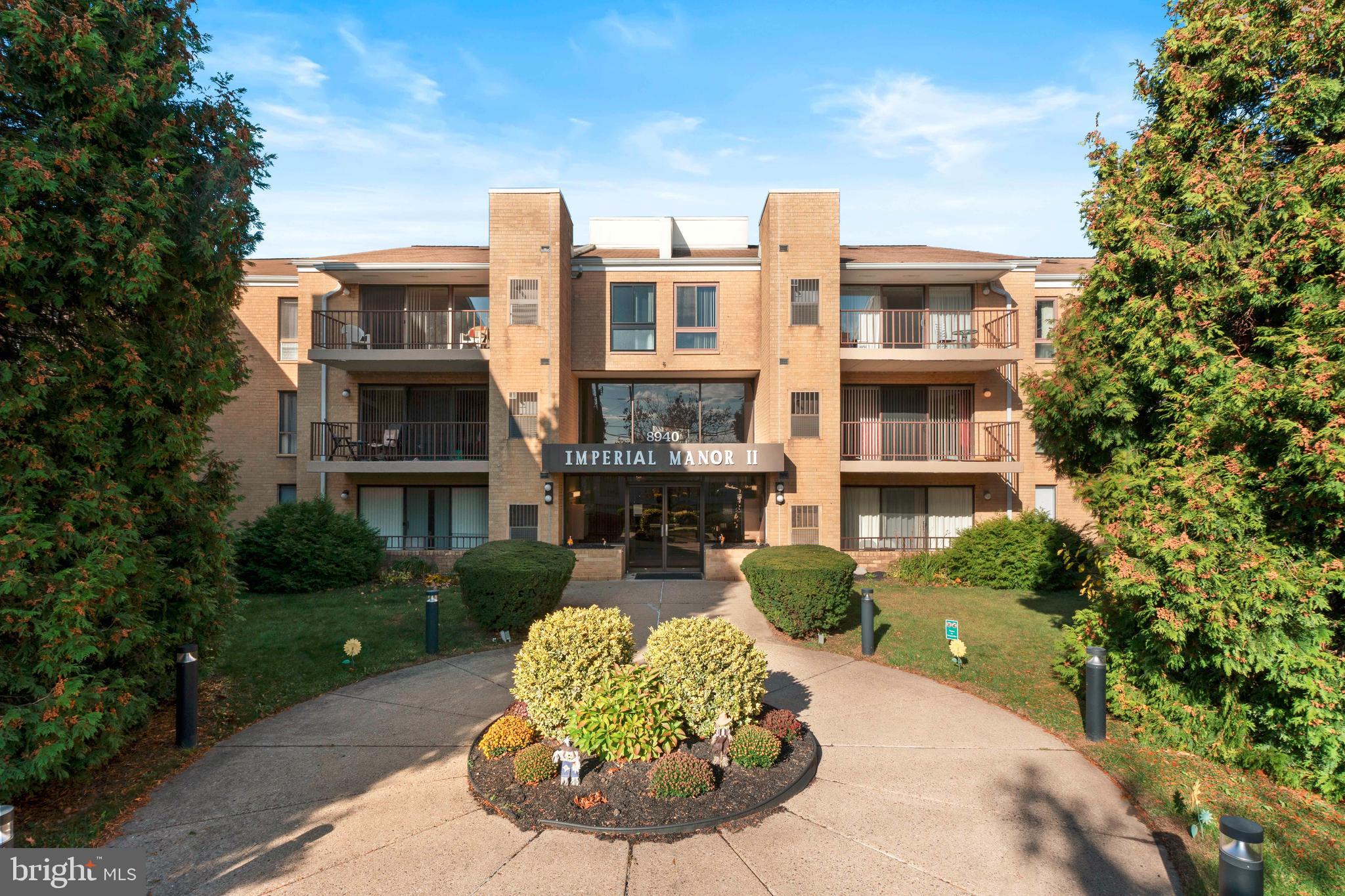 8940 Krewstown Road, Unit 204 Philadelphia, PA 19115 - Photo 1 of 23 a front view of a house with a yard