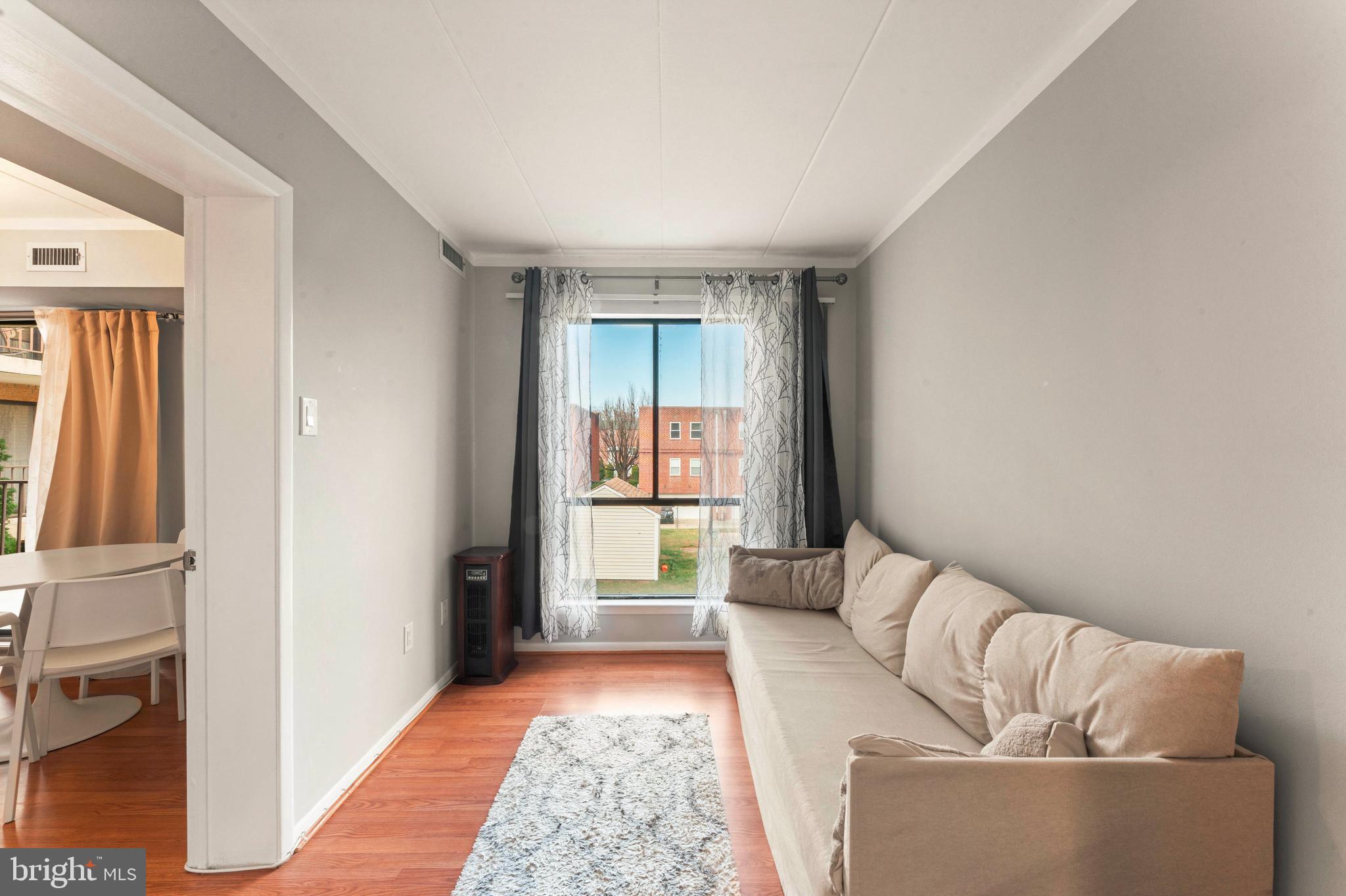 8940 Krewstown Road, Unit 204 Philadelphia, PA 19115 - Photo 13 of 23 a living room with furniture and a window
