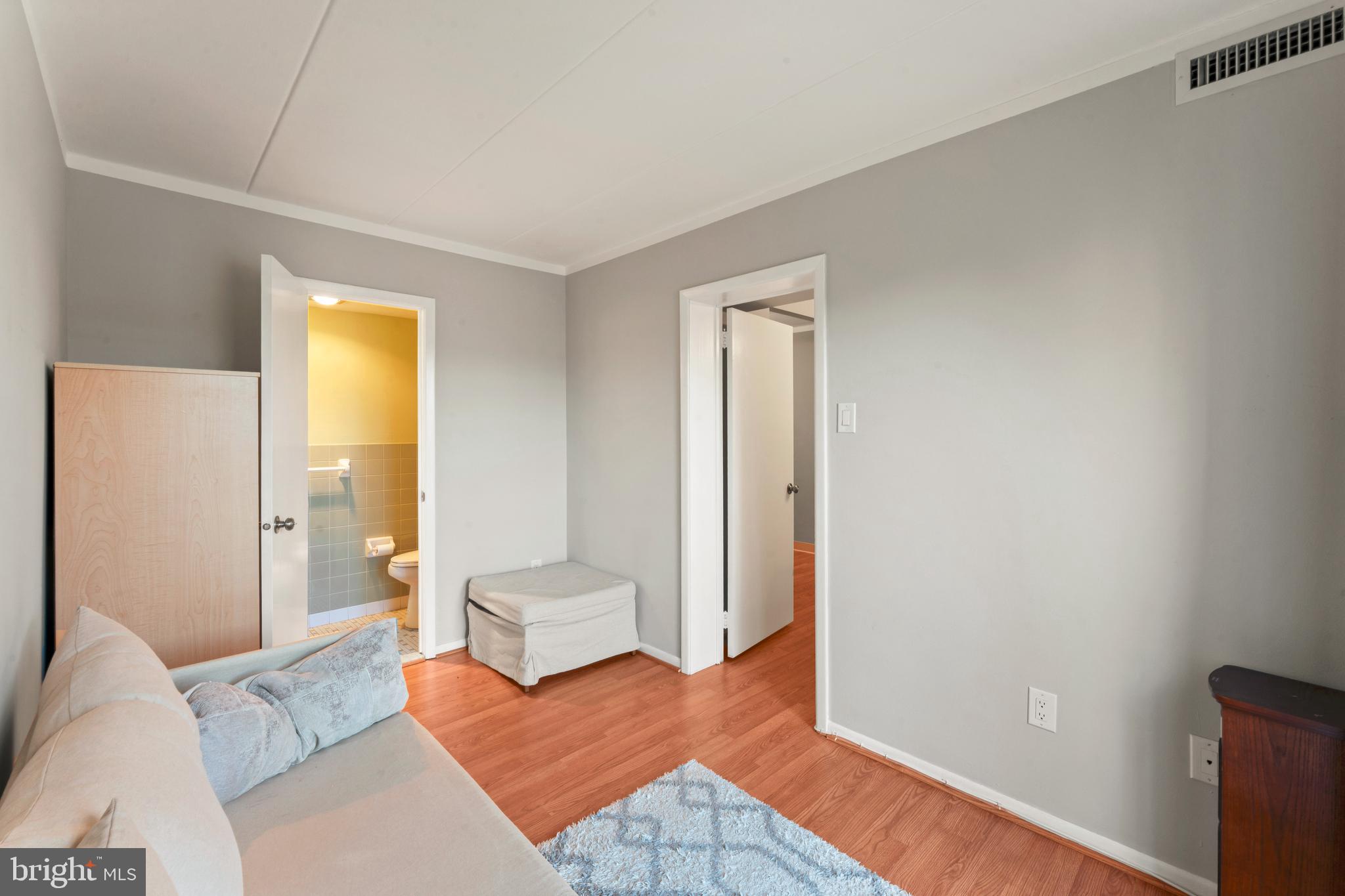 8940 Krewstown Road, Unit 204 Philadelphia, PA 19115 - Photo 14 of 23 a bedroom with a bed and a couch