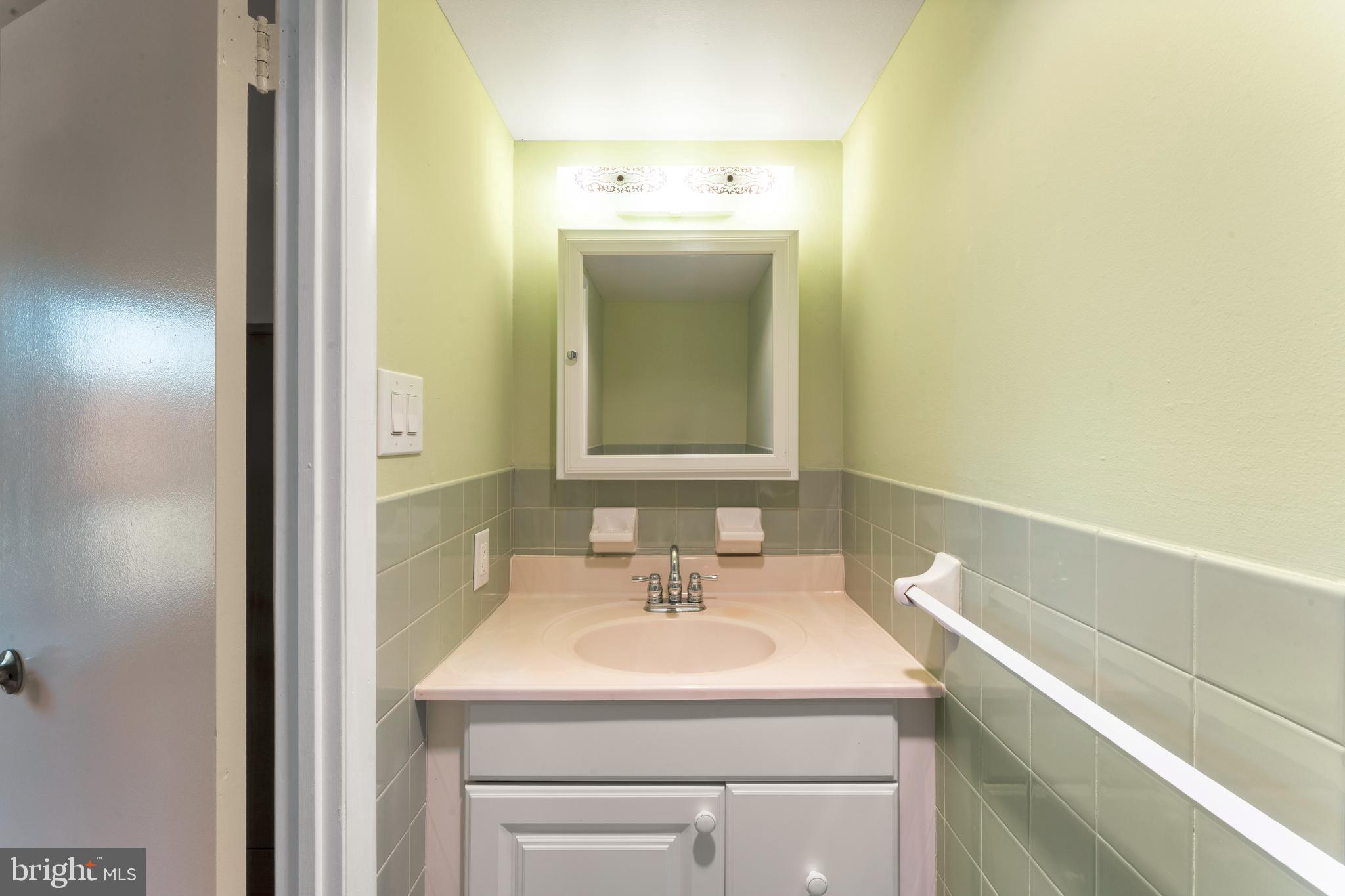 8940 Krewstown Road, Unit 204 Philadelphia, PA 19115 - Photo 15 of 23 a bathroom with a sink and a mirror