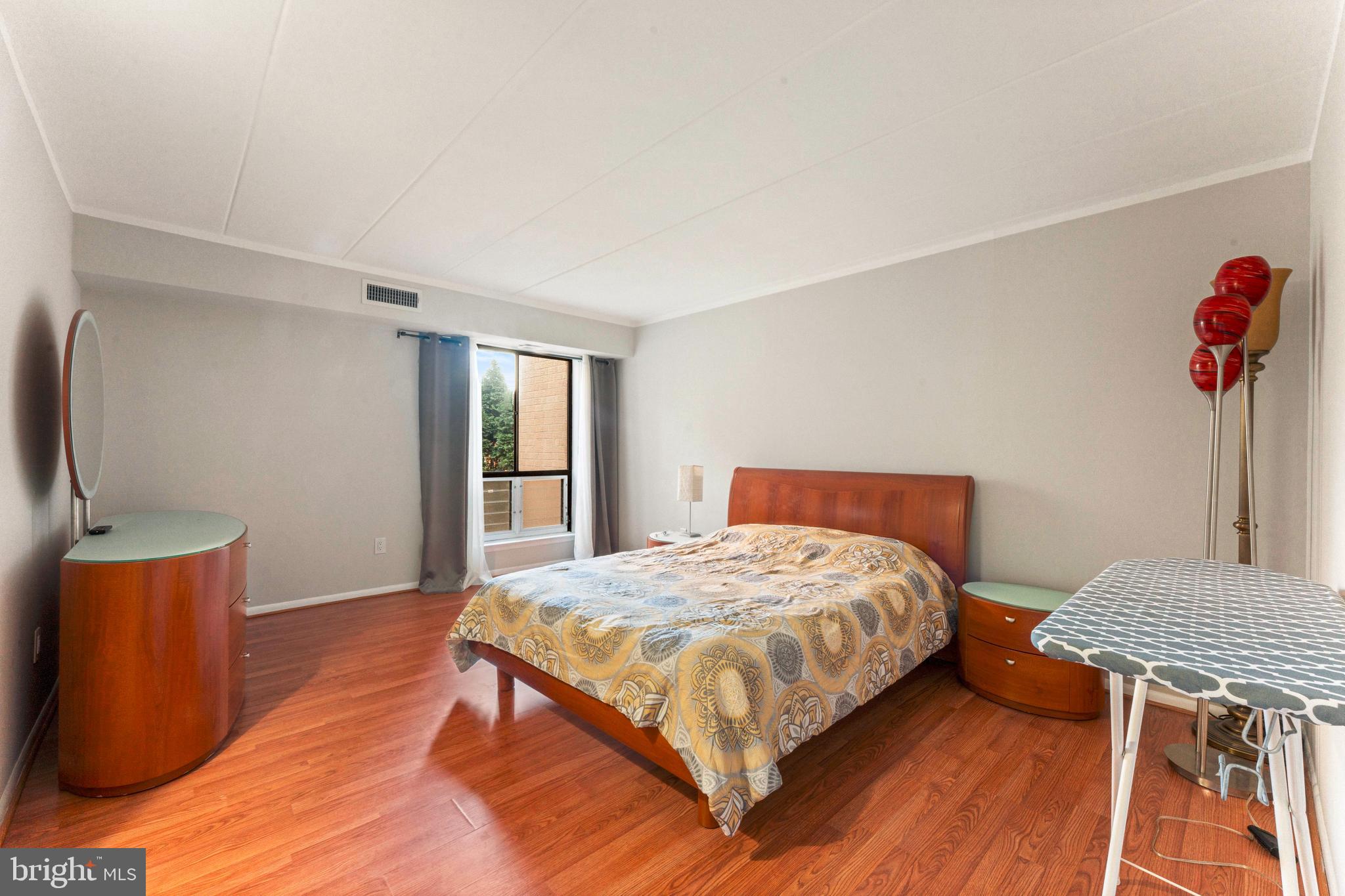 8940 Krewstown Road, Unit 204 Philadelphia, PA 19115 - Photo 16 of 23 a bedroom with a bed and wooden floor