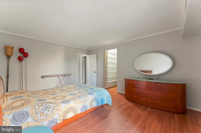 a bedroom with a bed and a mirror