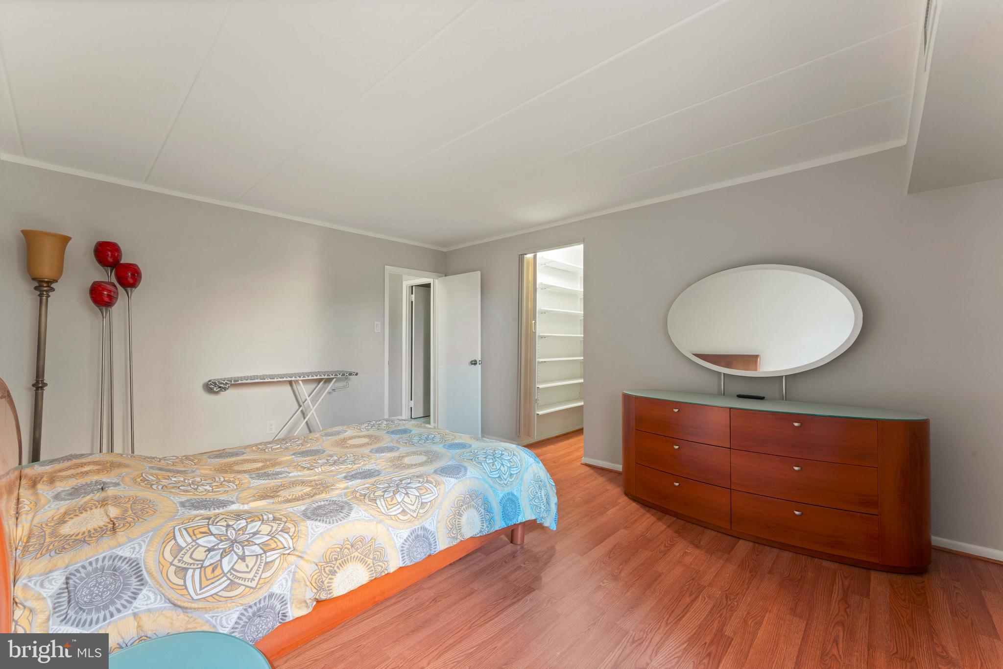 8940 Krewstown Road, Unit 204 Philadelphia, PA 19115 - Photo 17 of 23 a bedroom with a bed and a mirror