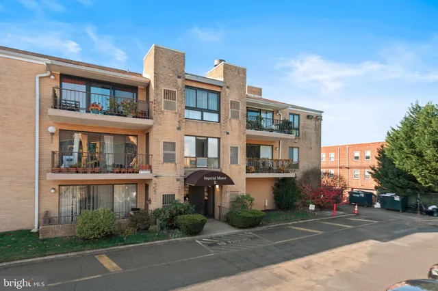 a front view of a residential apartment building with a yard