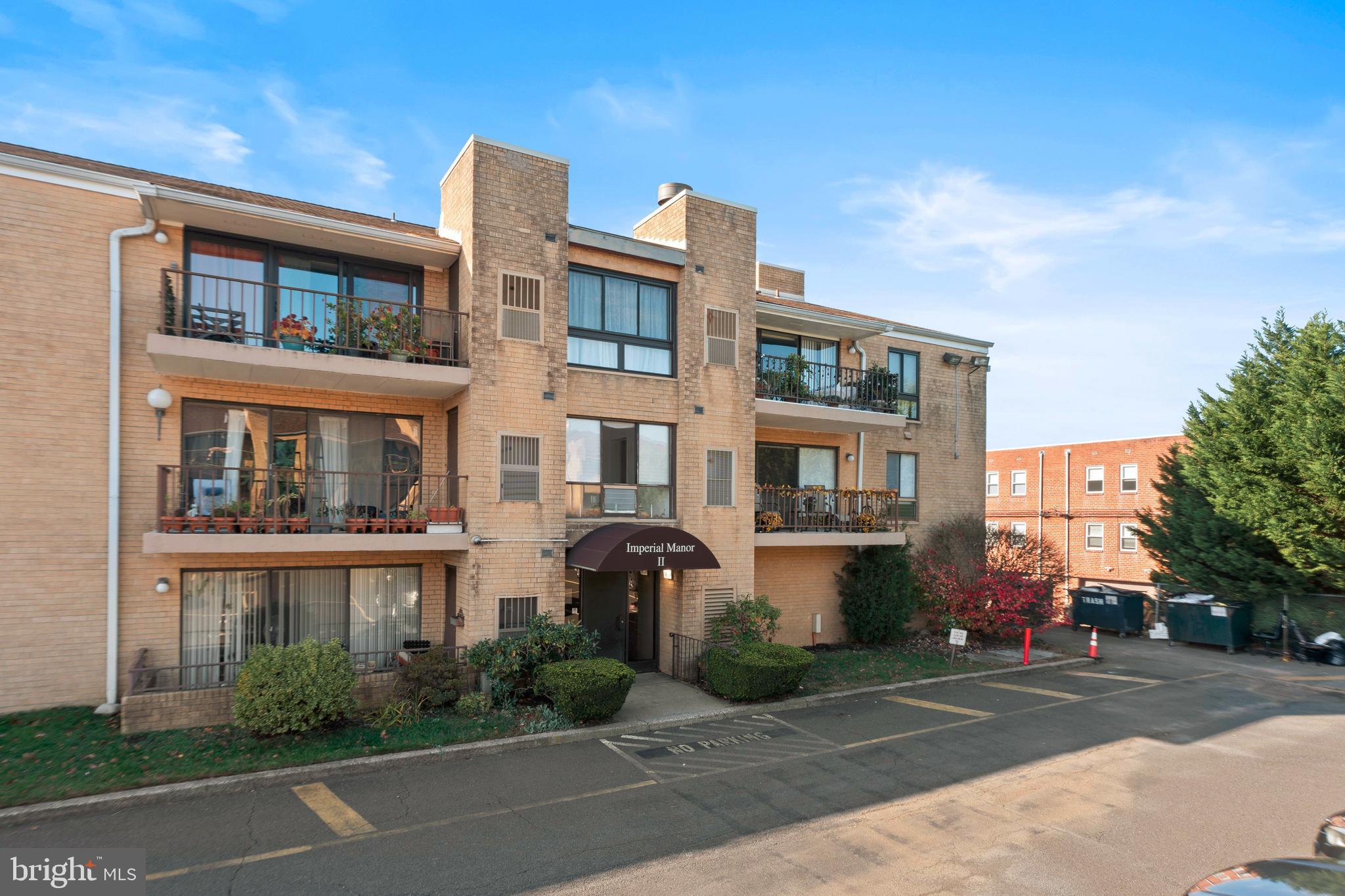 8940 Krewstown Road, Unit 204 Philadelphia, PA 19115 - Photo 2 of 23 a front view of a residential apartment building with a yard