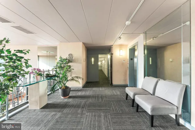 a lobby with furniture and potted plant