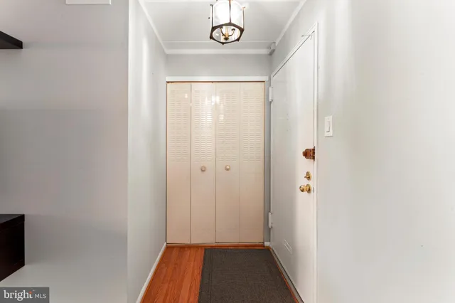 a view of a hallway with wooden floor