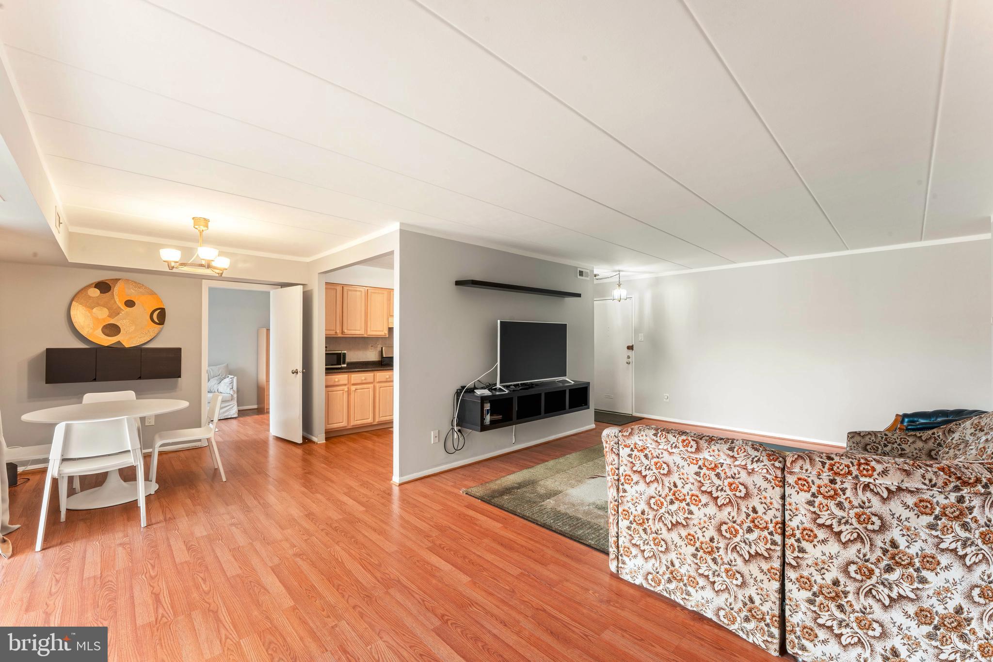 8940 Krewstown Road, Unit 204 Philadelphia, PA 19115 - Photo 7 of 23 a living room with furniture and a flat screen tv