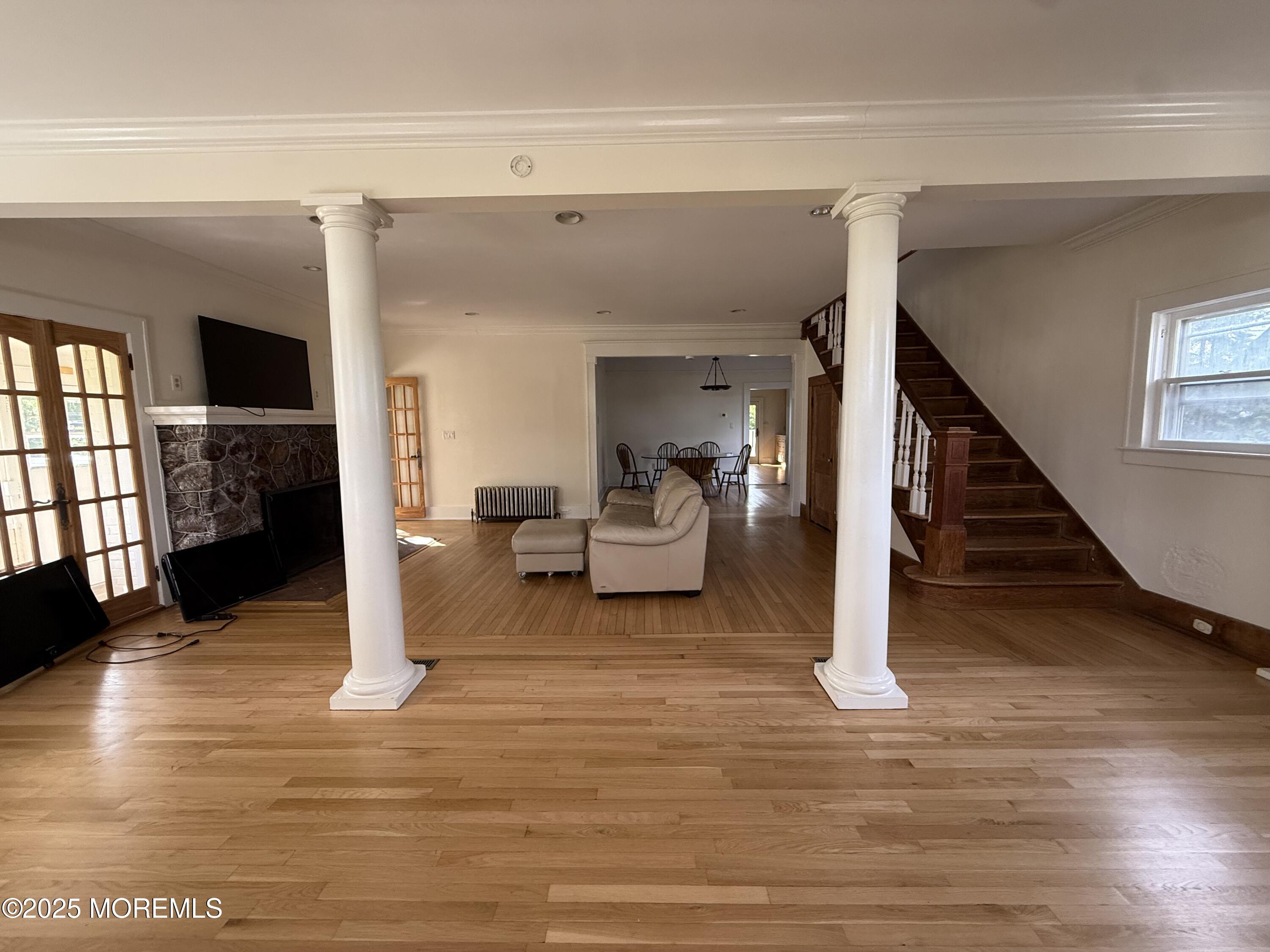 a living room with furniture and a wooden floor