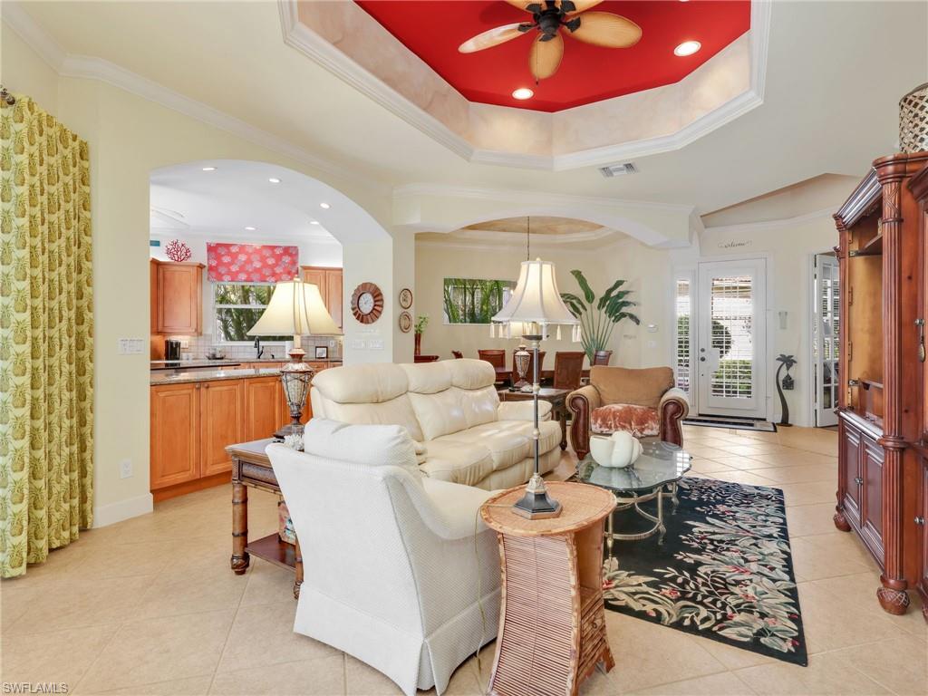 353 Steerforth Court Naples, FL 34110 - Photo 13 of 40 a living room with furniture and a chandelier