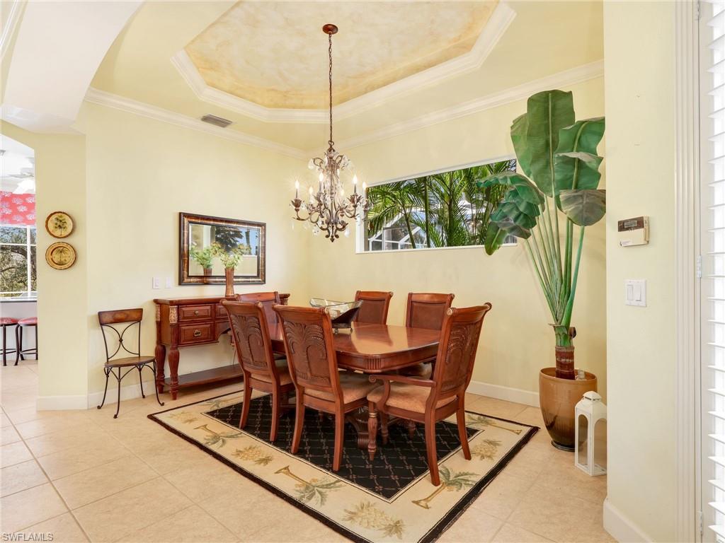 353 Steerforth Court Naples, FL 34110 - Photo 14 of 40 a view of a dining room with furniture wooden floor and chandelier