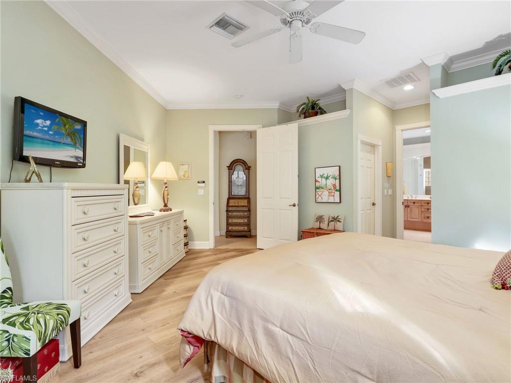 353 Steerforth Court Naples, FL 34110 - Photo 19 of 40 a bedroom with a bed and a dresser