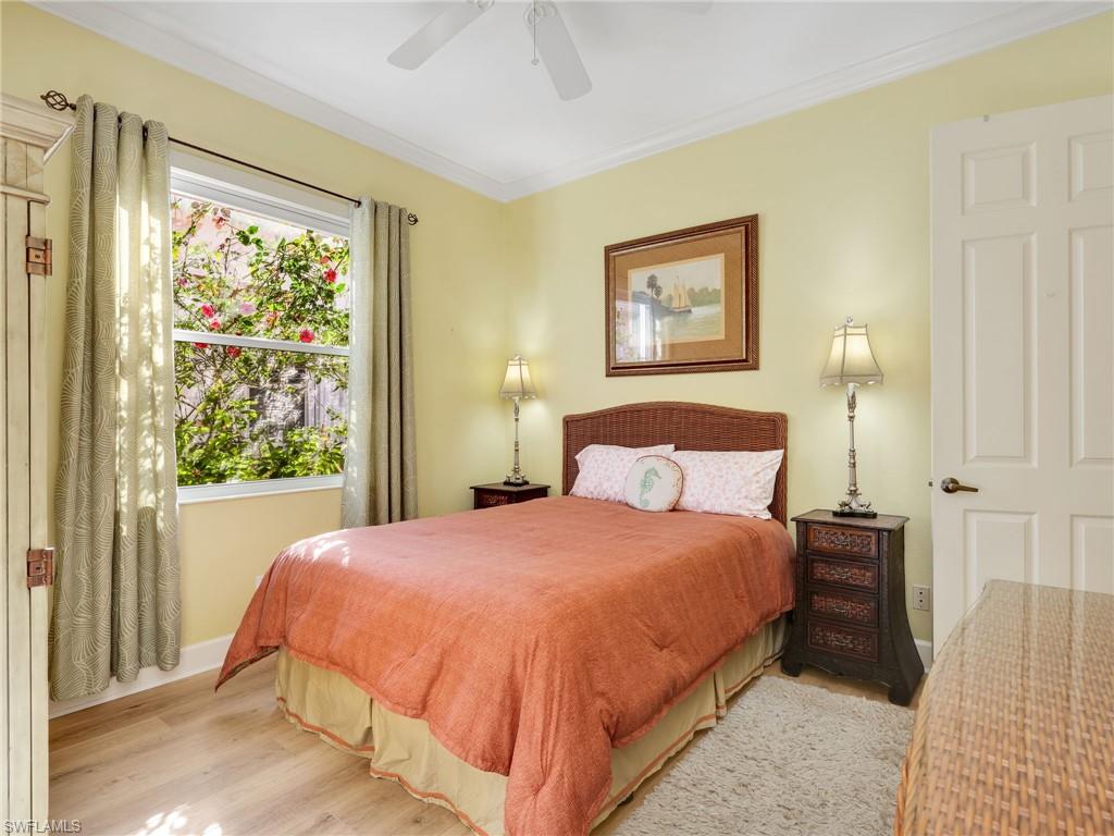 353 Steerforth Court Naples, FL 34110 - Photo 22 of 40 a bedroom with a bed and a window