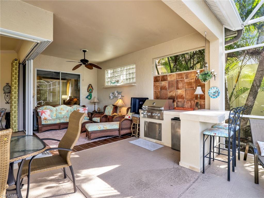 353 Steerforth Court Naples, FL 34110 - Photo 34 of 40 a living room with furniture and a large window