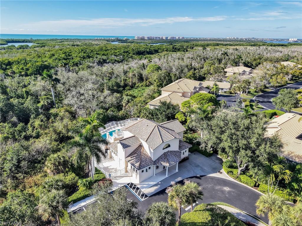 353 Steerforth Court Naples, FL 34110 - Photo 39 of 40 an aerial view of a house with a lake view