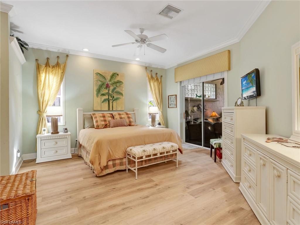 353 Steerforth Court Naples, FL 34110 - Photo 6 of 40 a spacious bedroom with a bed and ceiling fan