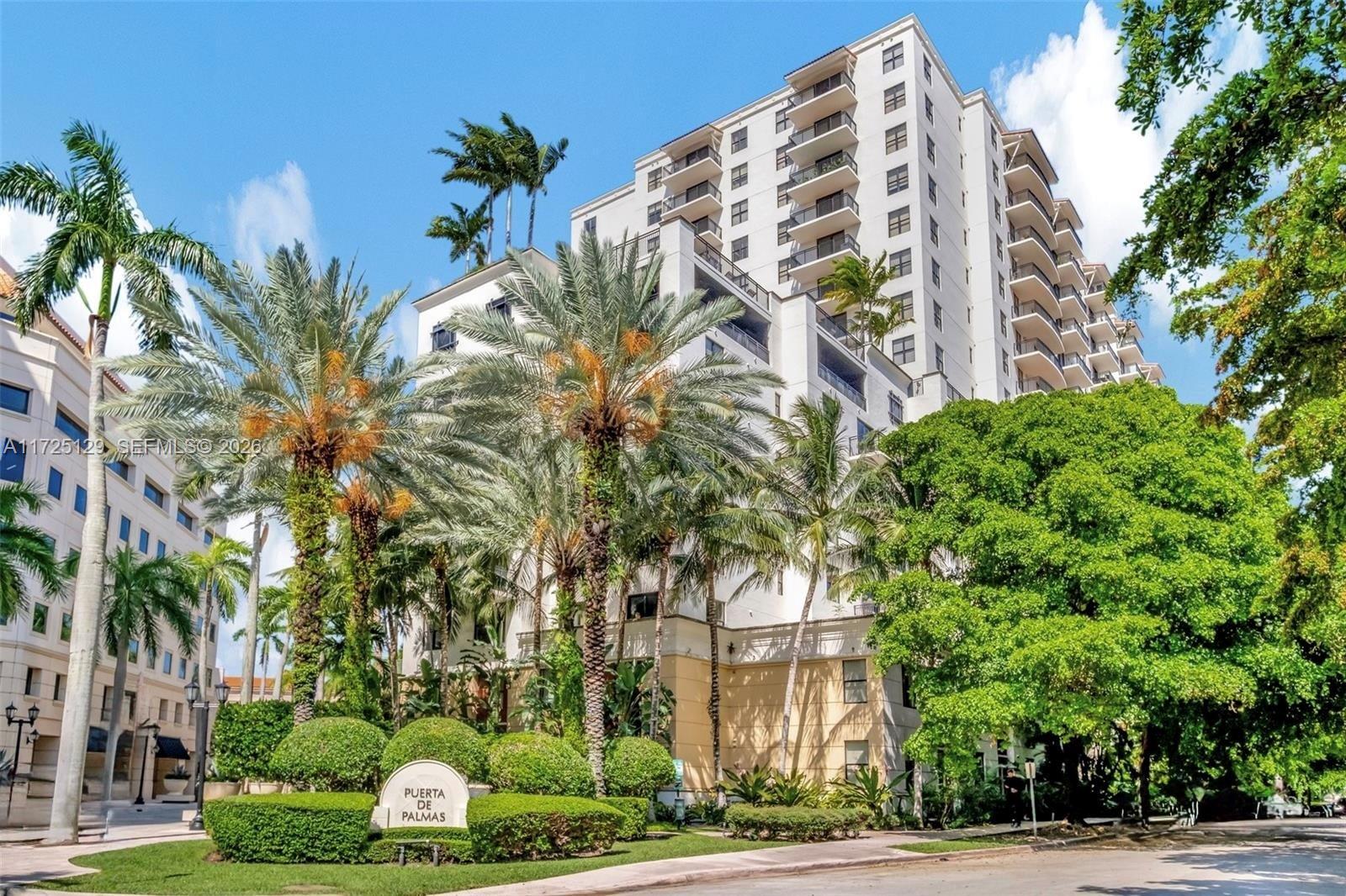 888 Douglas Road, Unit 1210 Coral Gables, FL 33134 - Photo 1 of 29 a view of a tall building next to a yard
