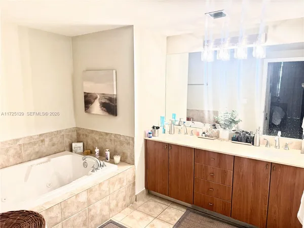 a bathroom with a bathtub sink and mirror