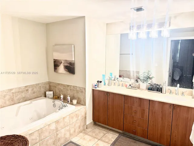 a bathroom with a bathtub sink and mirror