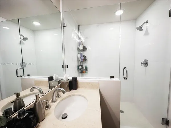 a bathroom with a tub sink and mirror