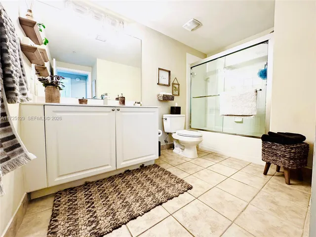 a living room with a baby crib and a couch