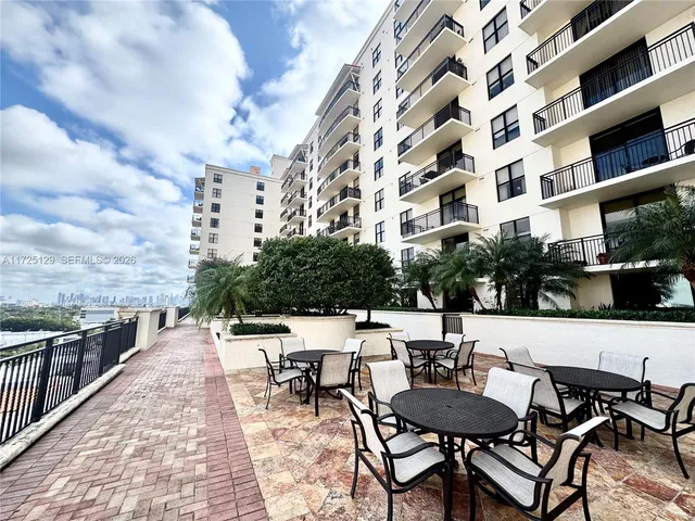 a view of a chairs and table in patio