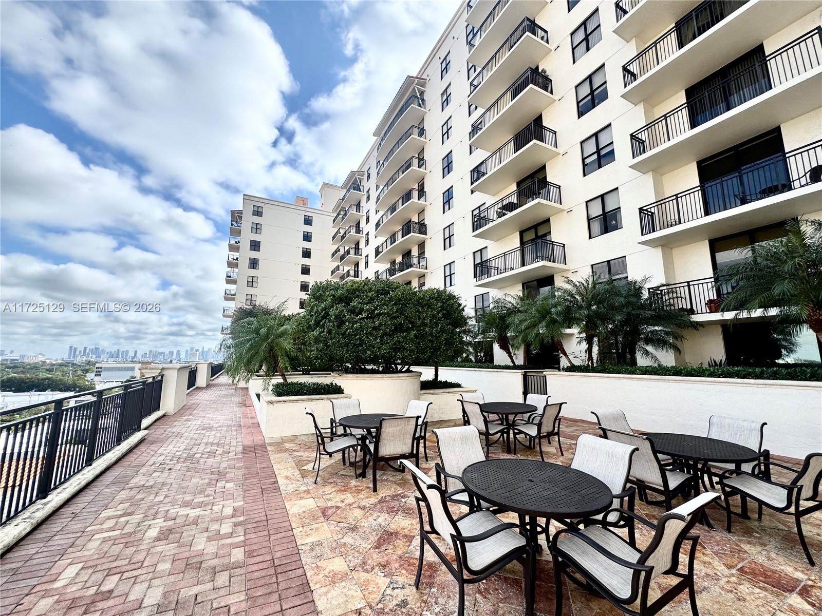 888 Douglas Road, Unit 1210 Coral Gables, FL 33134 - Photo 28 of 29 a view of a chairs and table in patio