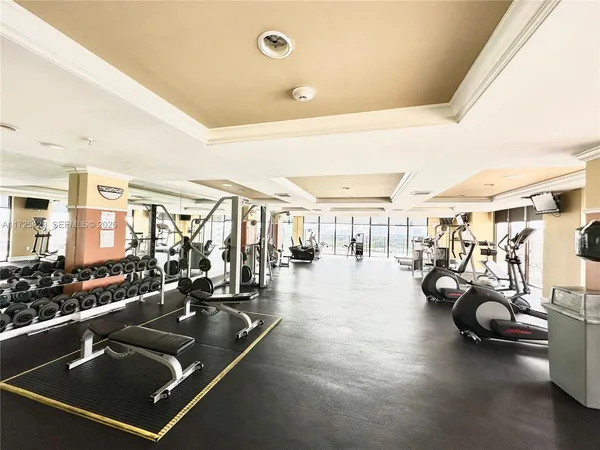 a living room with lots of gym equipment