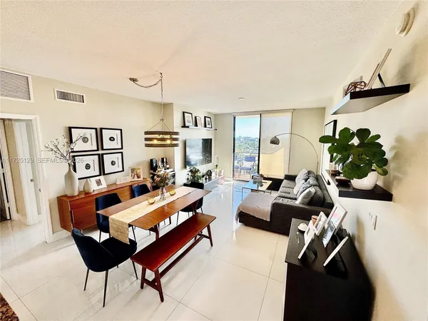 a living room with furniture potted plant and a window