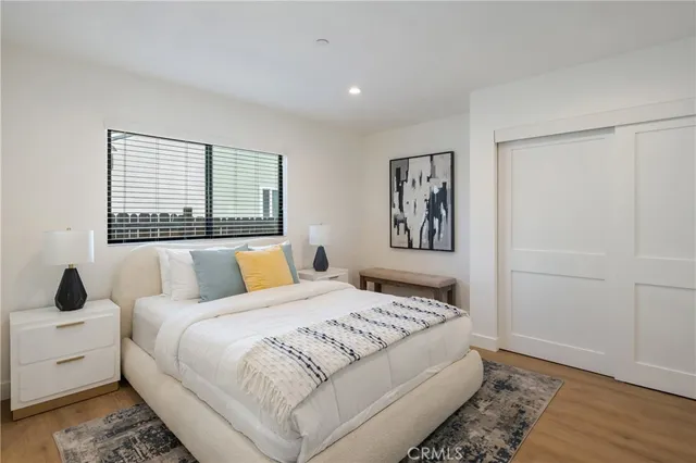 a bedroom with a large bed and a window