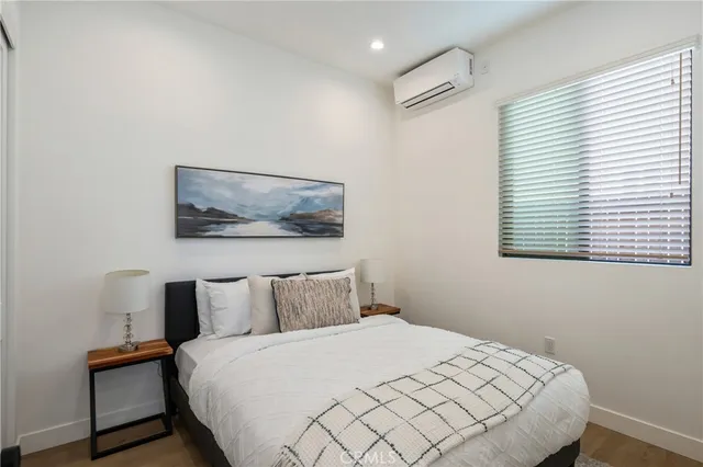 a bedroom with a bed and a painting on the wall