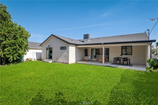 a view of a house with backyard porch and garden