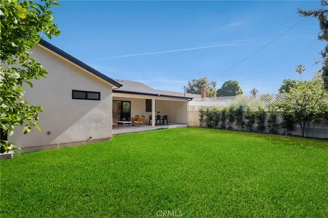 a front view of a house with a garden and plants