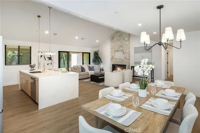 a living room with furniture kitchen and a chandelier