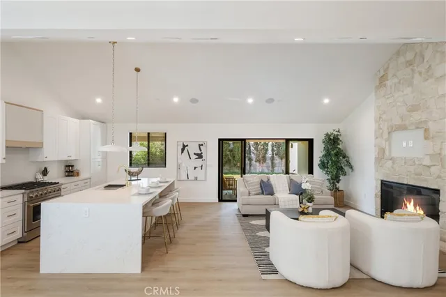 a living room with fireplace furniture and a wooden floor