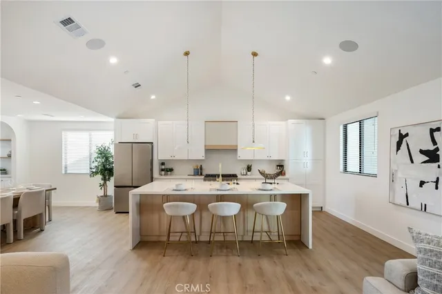 a large kitchen with a table and chairs