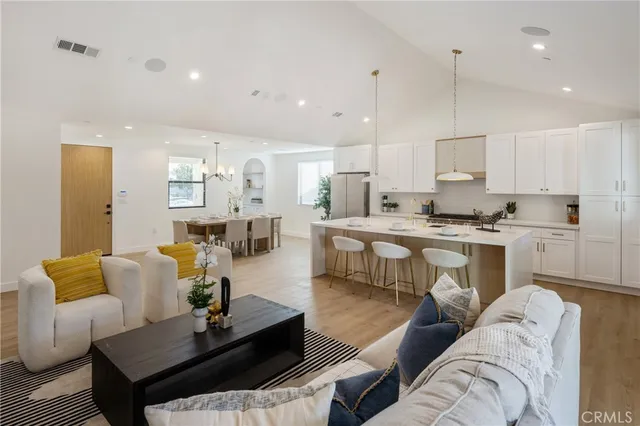 a living room with furniture kitchen and a table