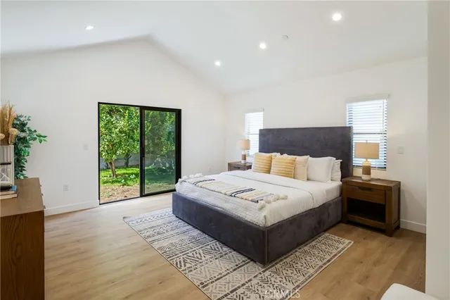 a spacious bedroom with a bed and a large window