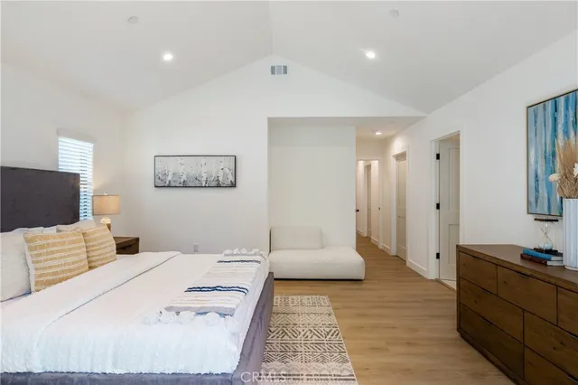 a bedroom with a bed and a couch